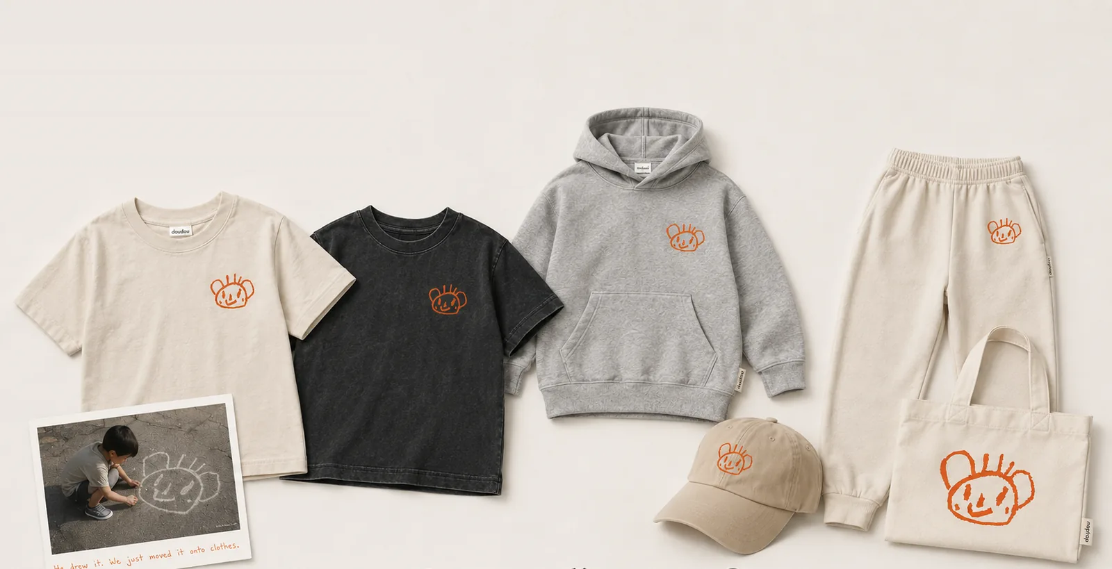 Drop 001 laid out: bone and charcoal tees, heather grey hoodie, bone sweatpants, cap and tote, all with the chalk drawing
